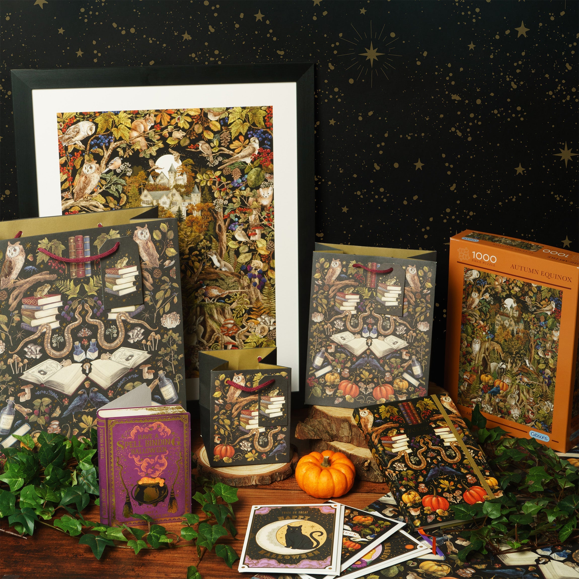 A table laid out with autumn gifts such as a wall art print, gift bag, cards, and jigsaw puzzle.