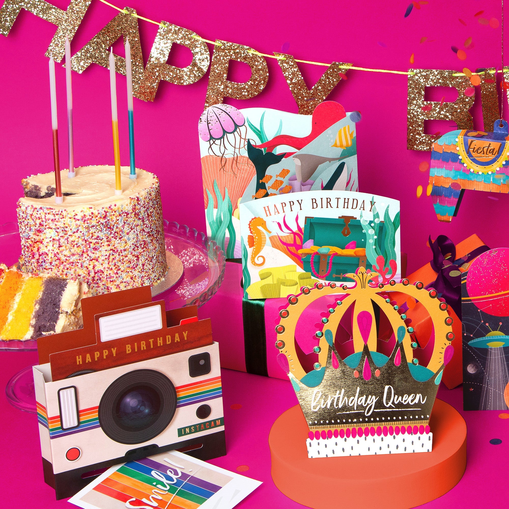 3D and pop-up cards displayed on a pink table.