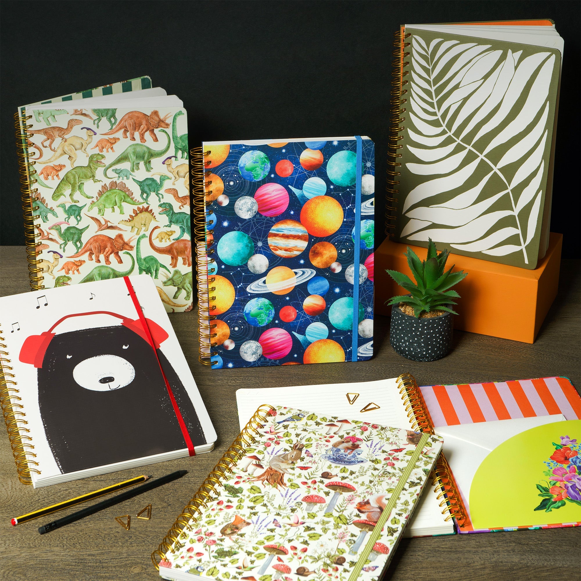 A selection of A4 notebooks displayed on a table.