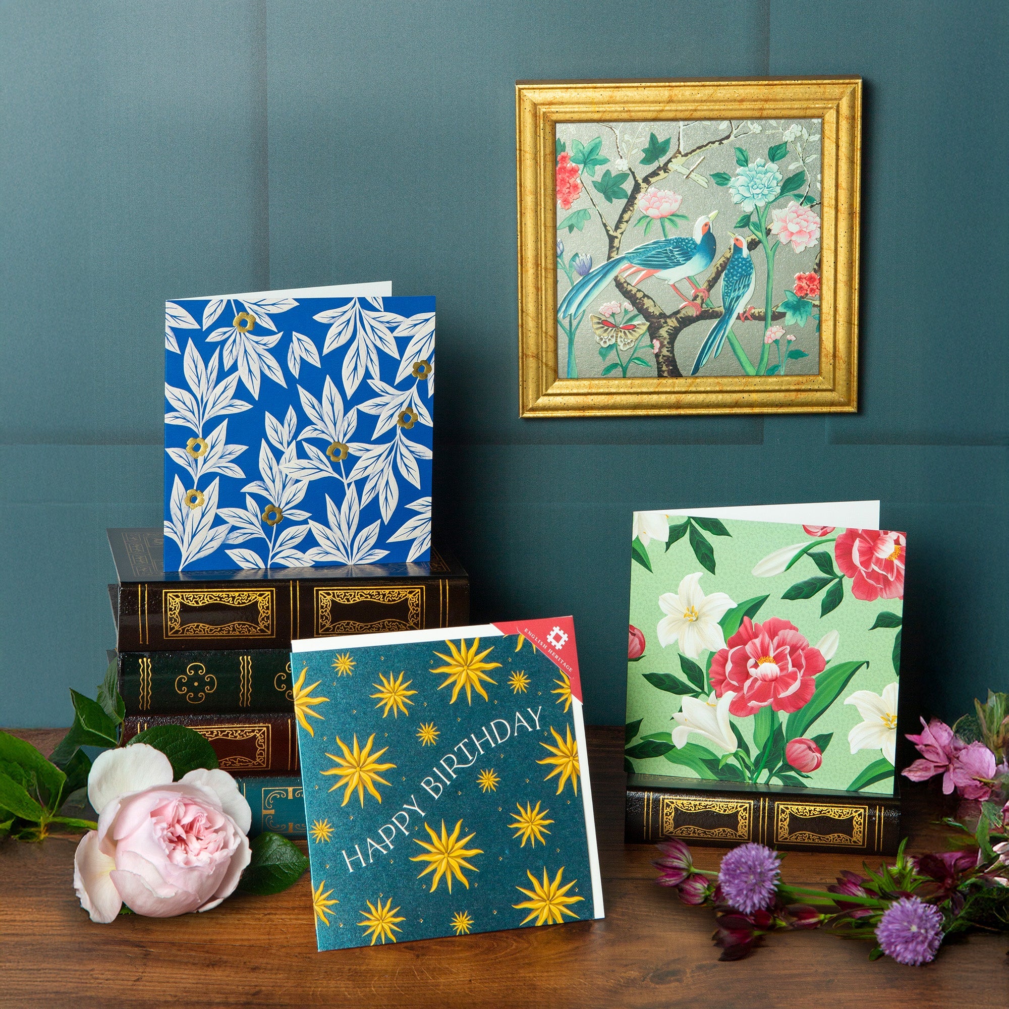 A beautiful series of cards featuring patterns from English Heritage buildings, displayed with flowers on a table.