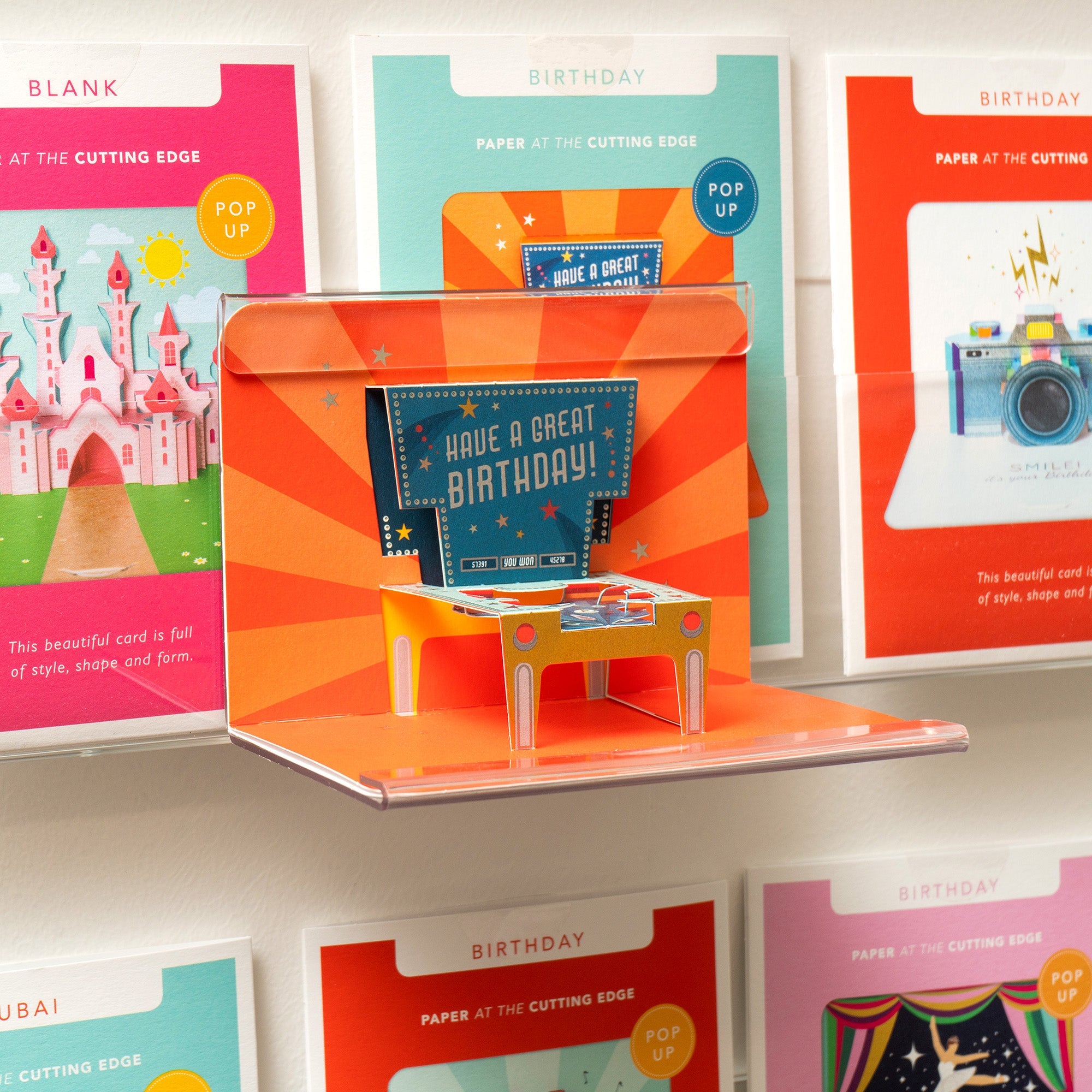 A collection of Form Pop-Up cards in display on a wall.