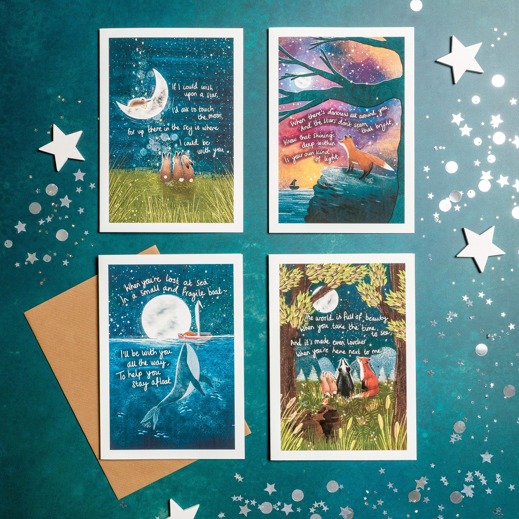 A collection of Fox Under The Moon cards displayed on a table decorated with stars.