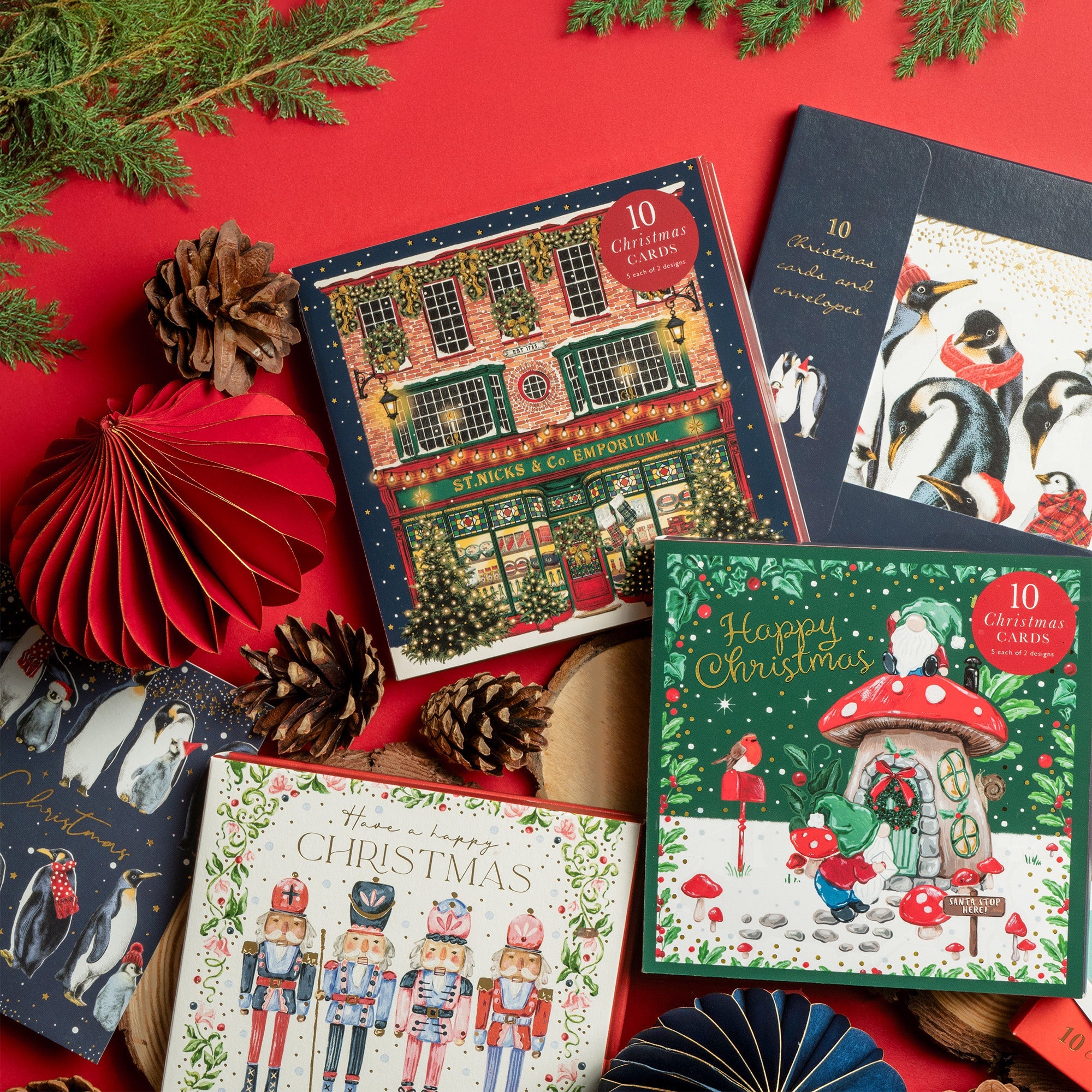Christmas card wallets full of festive cards laid out with lots of festive decorations.