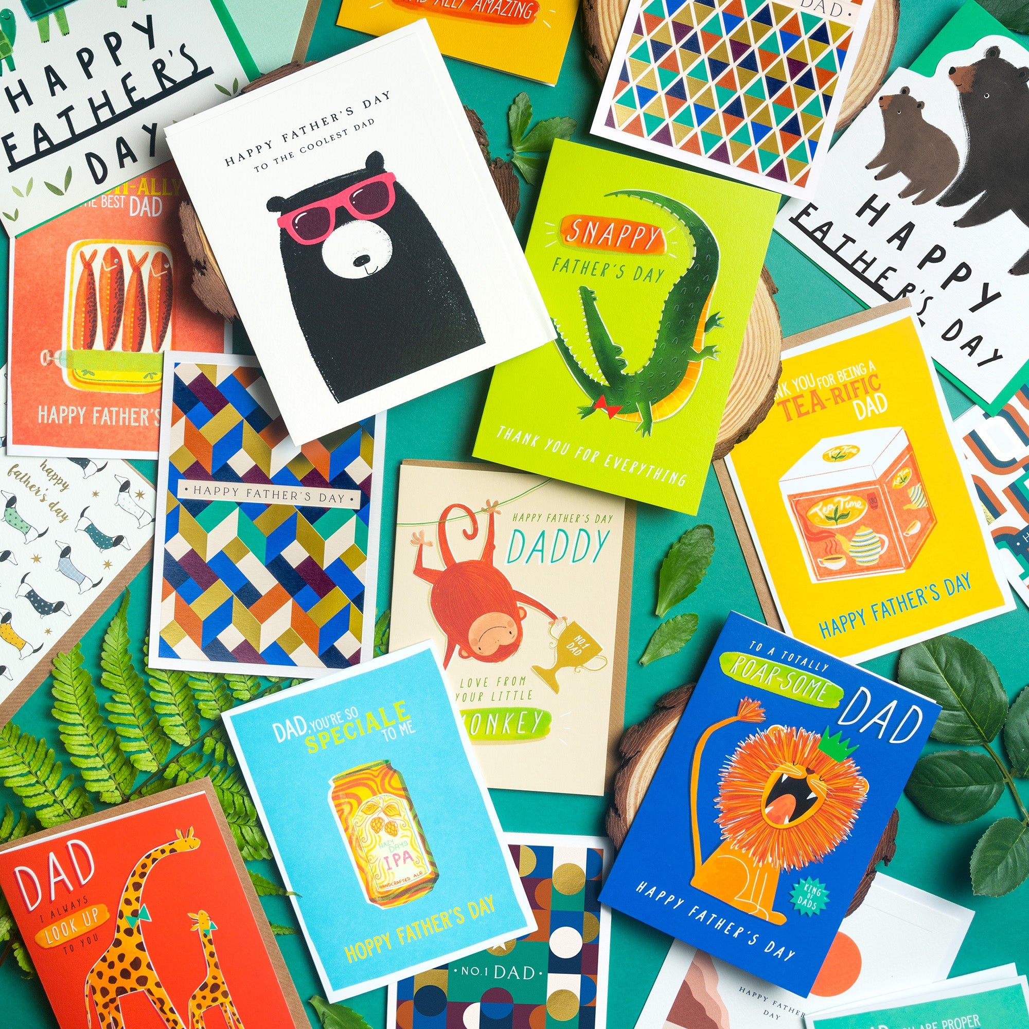 A full display of different Father's Day cards laid out on a table together in a jumble.