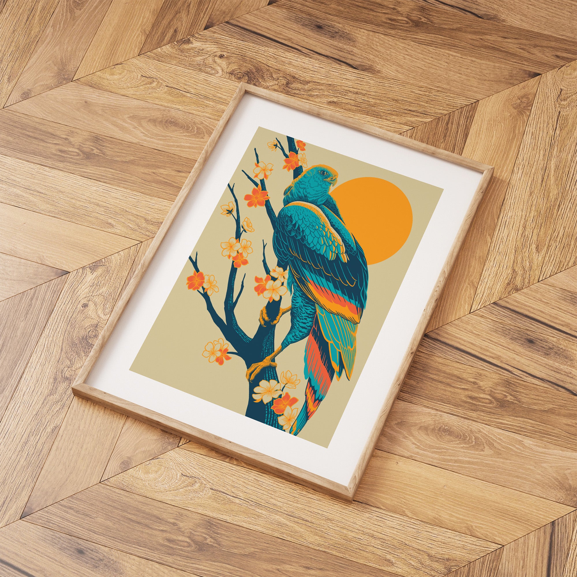 Framed print featuring a detailed illustration of a peregrine falcon perched in front of a brilliant sunrise. Print is laid out on a wooden floor.