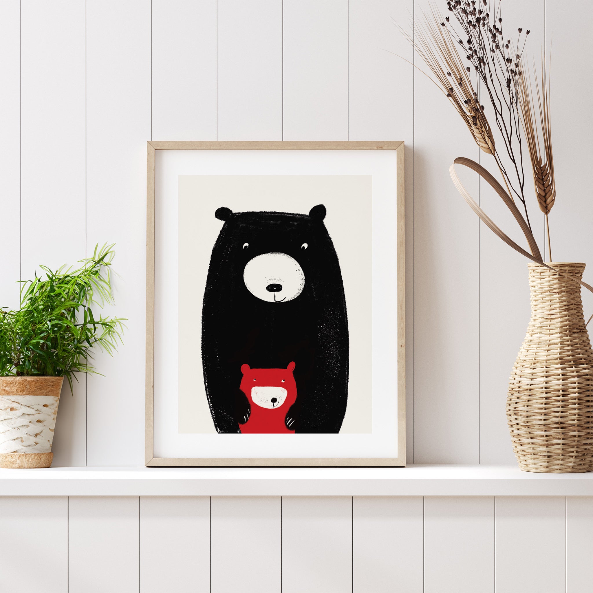 Framed illustration of a bear with a smaller bear inside on a white wall.