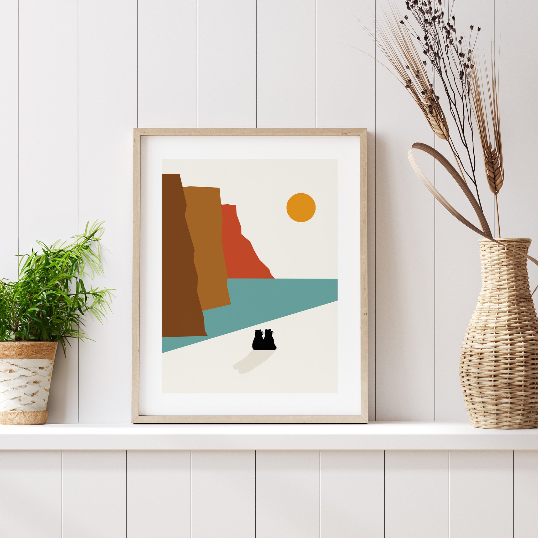 Framed abstract art print on a white wall with decorative elements.