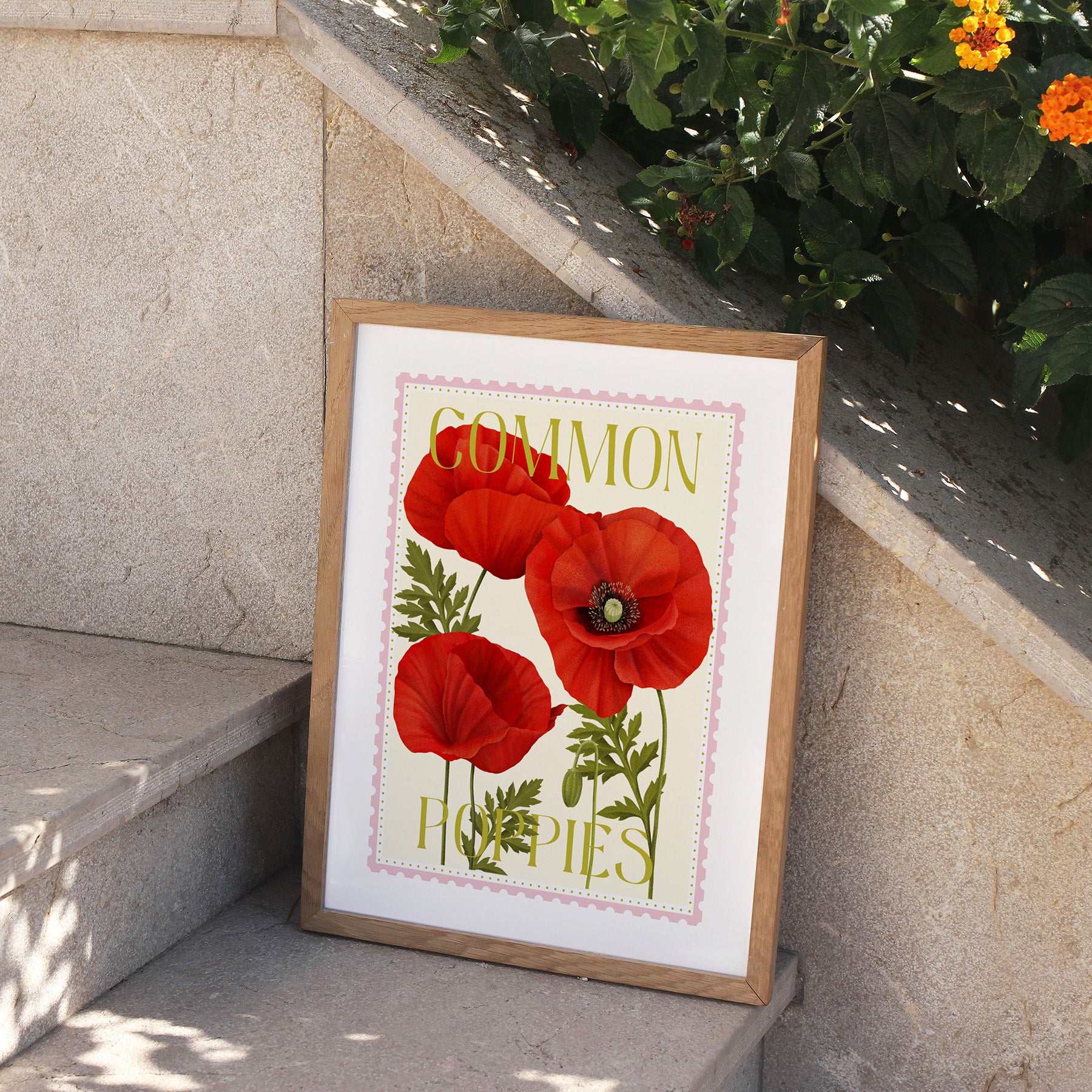 Framed print of red poppies with 'Common Poppies' text on a stone ledge.