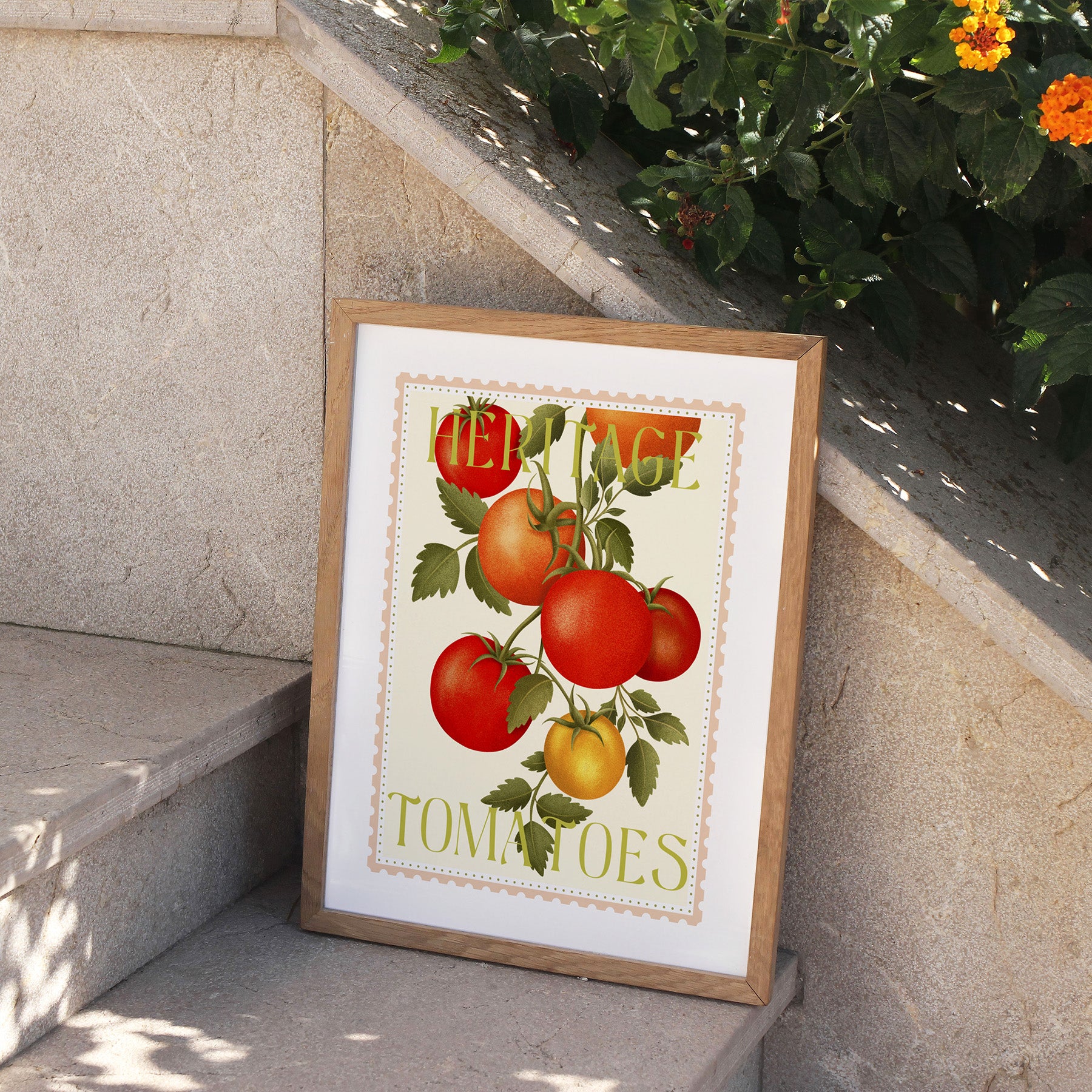 Framed artwork of tomatoes on a stone ledge with plants in the background