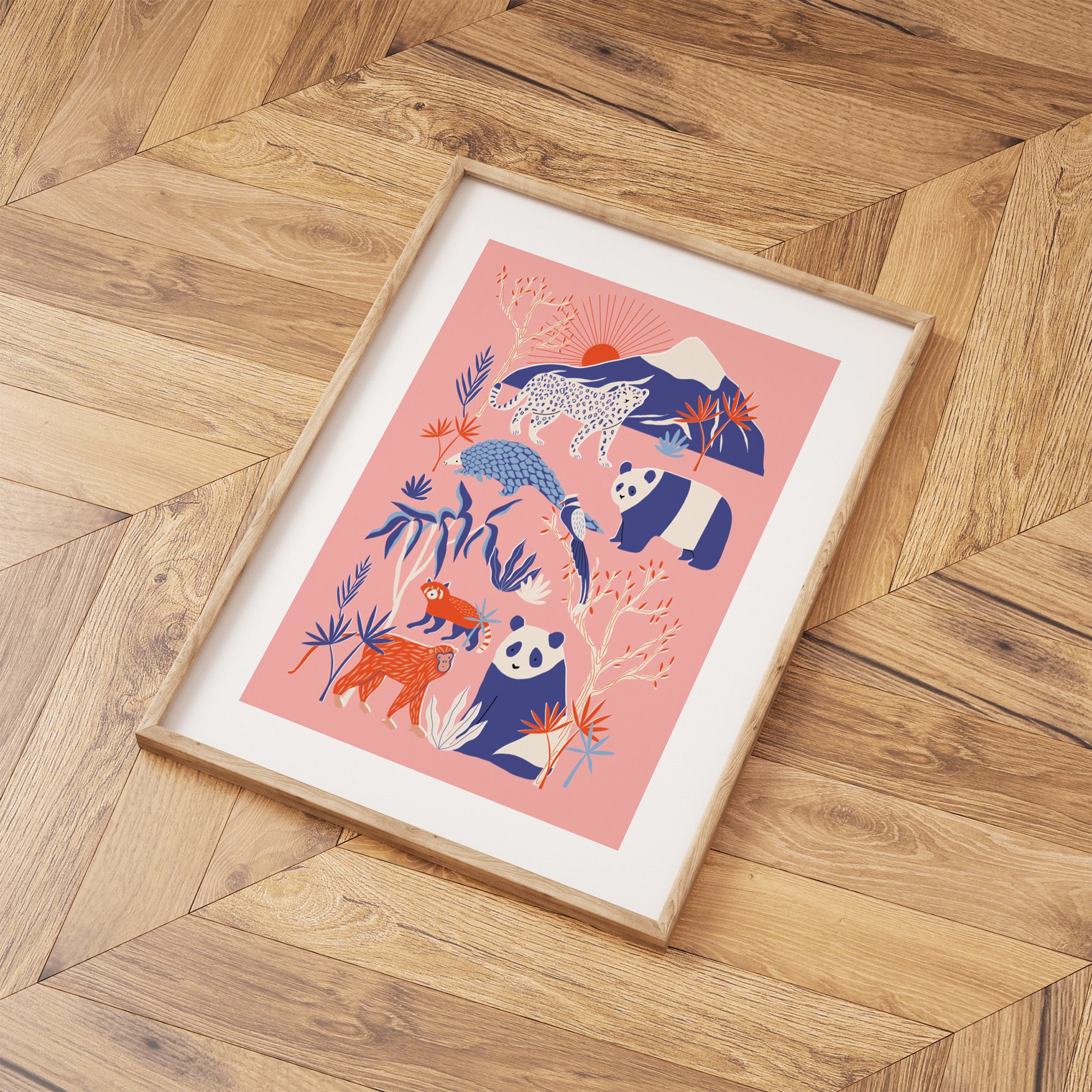 Framed artwork with animal illustrations on a wooden floor.