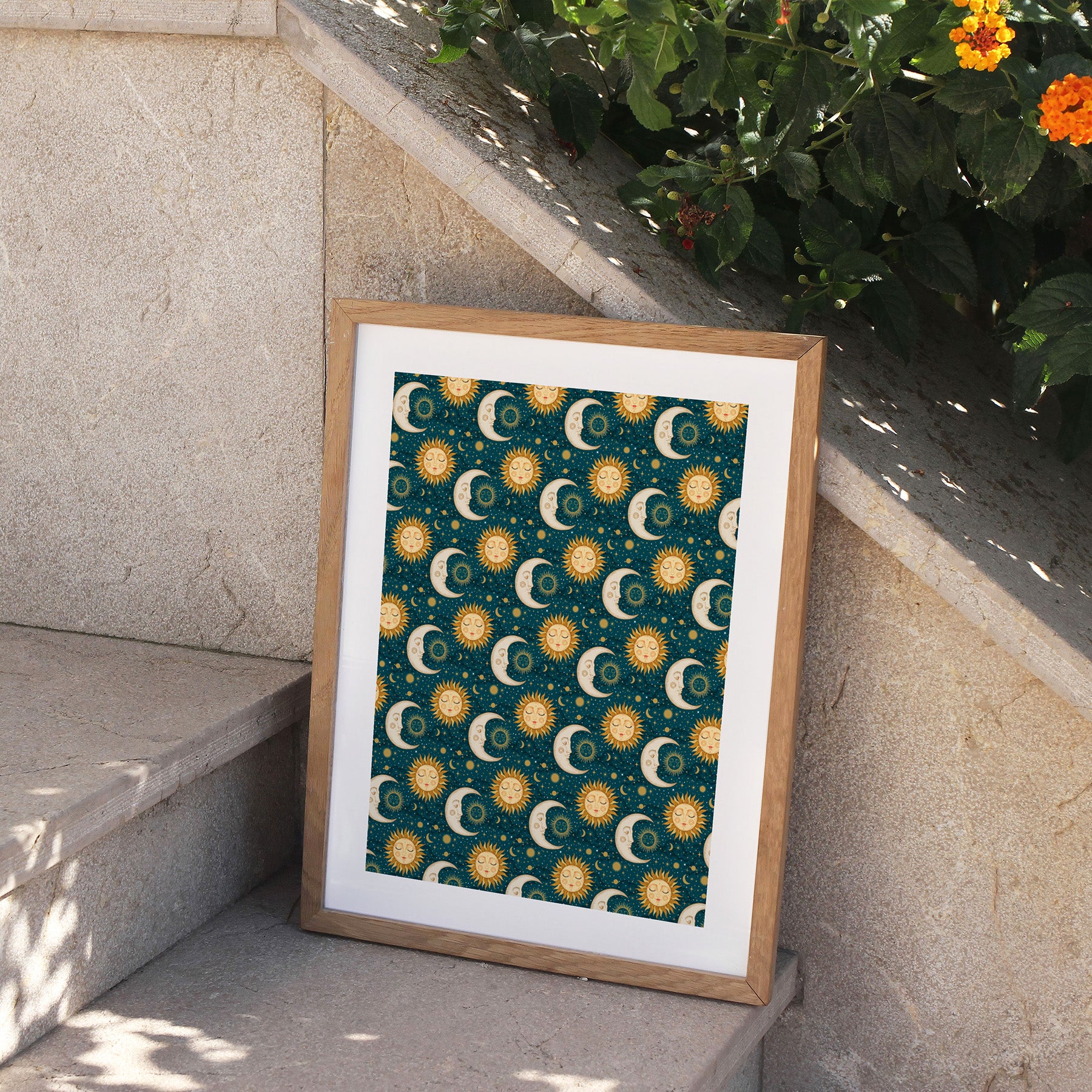 Framed artwork with celestial pattern on a stone ledge.