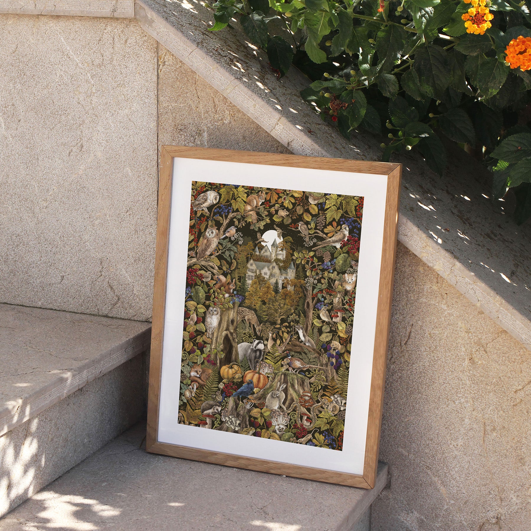 Framed artwork of a nature scene with animals and plants on a stone ledge.