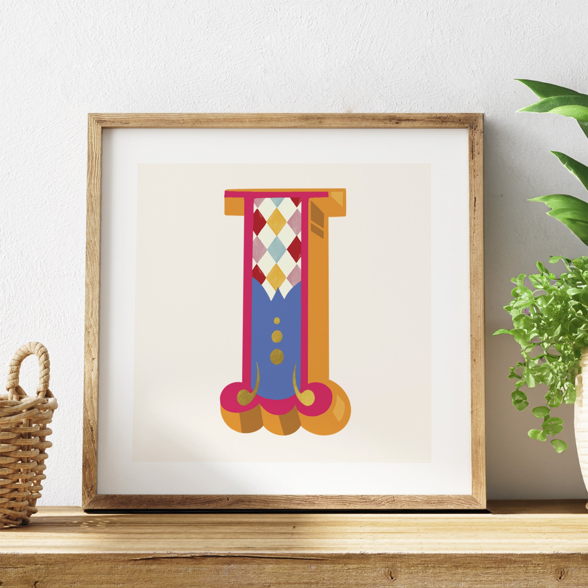 Framed colourful abstract art piece on a shelf with a plant in the background.