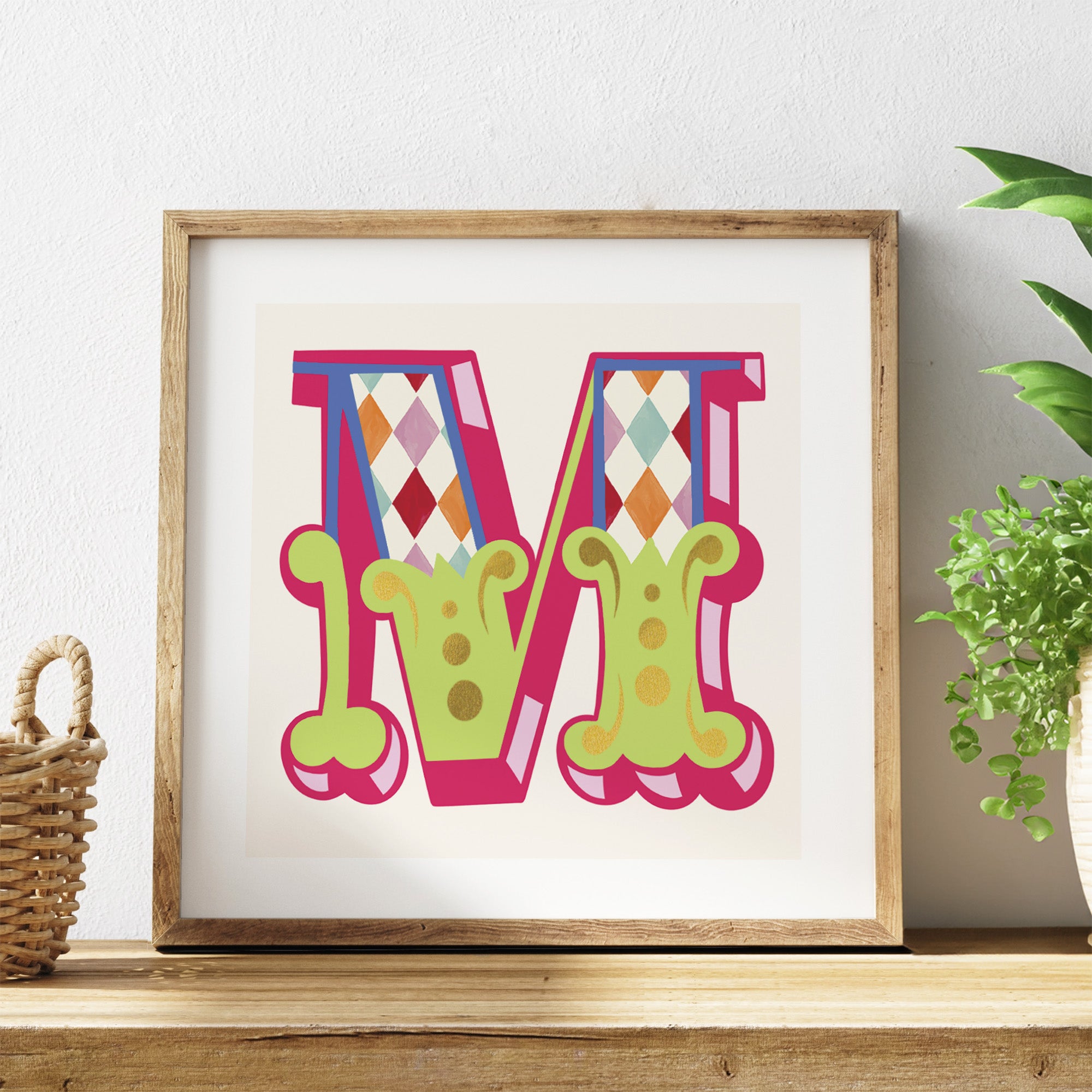 Framed colourful letter 'M' on a white background with a wooden frame.