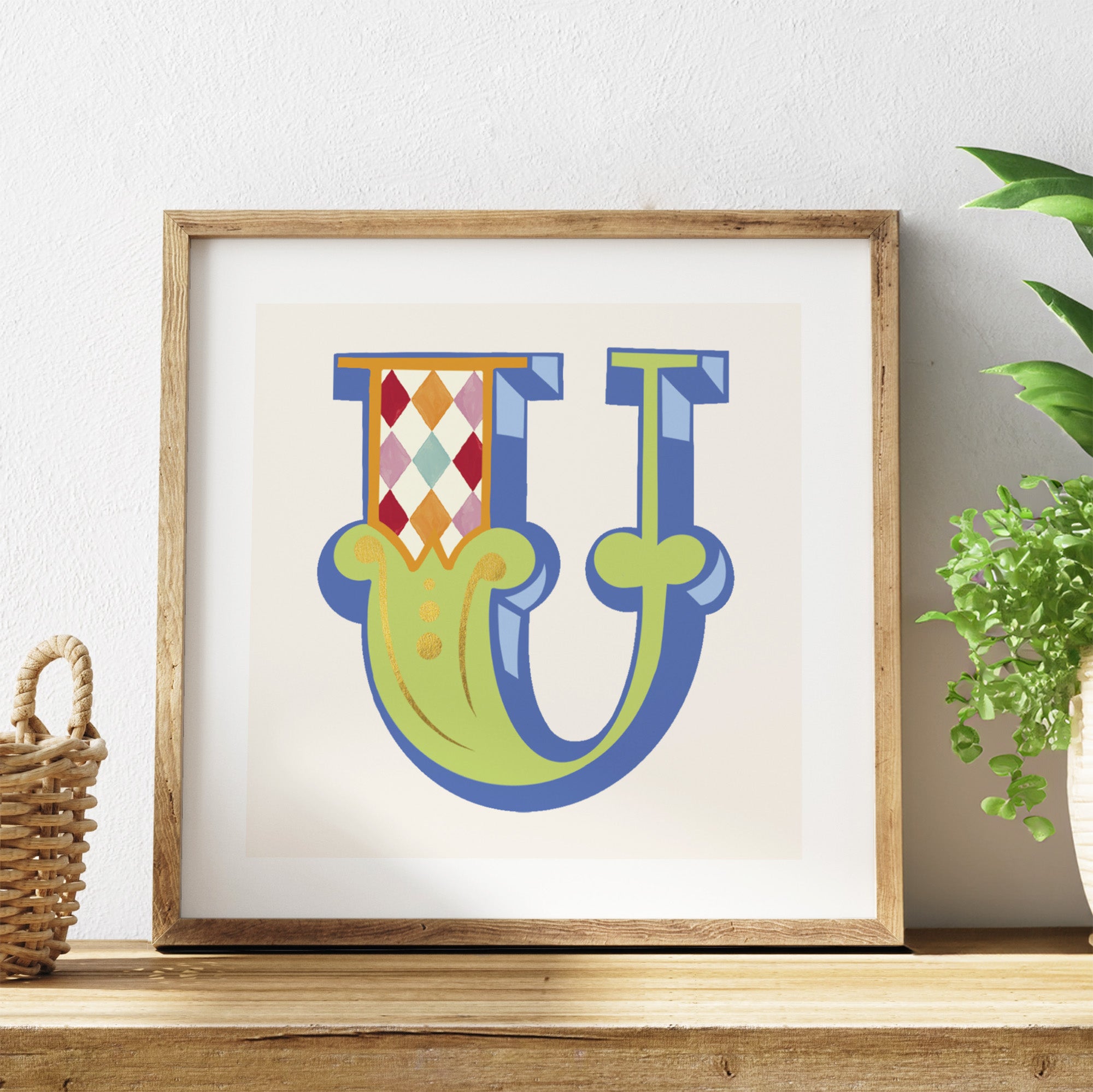Framed artwork with a colourful letter 'U' design on a white background.