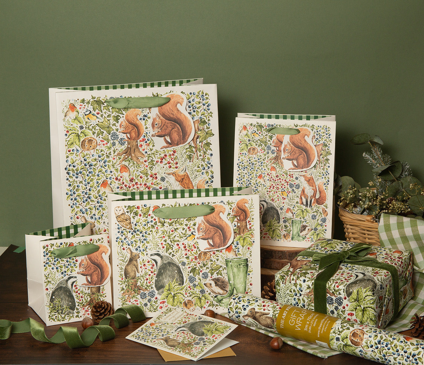 Wrapped Christmas present next to a Christmas gift bags