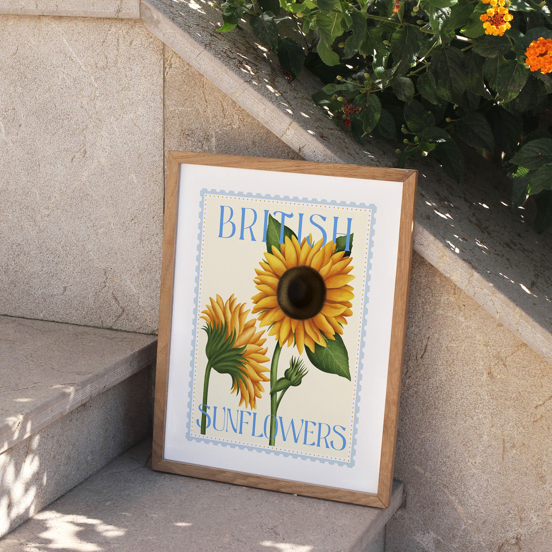 Framed print of sunflowers with 'British Sunflowers' text on a stone ledge.