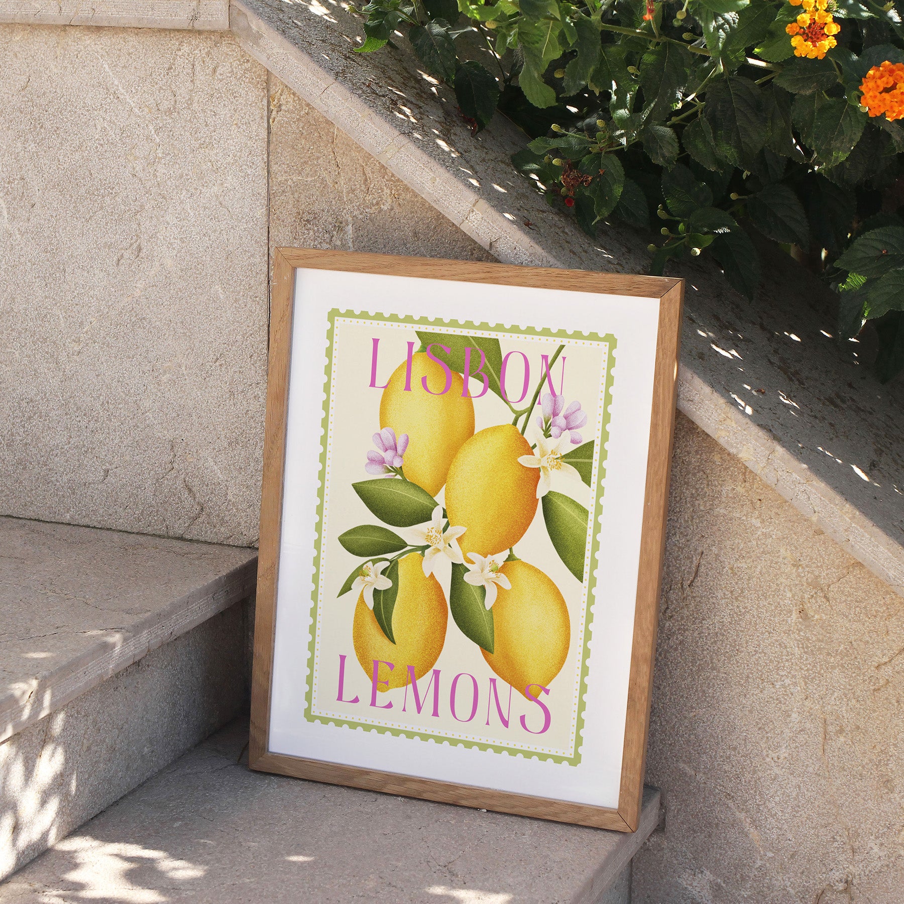 Framed artwork with lemons and 'Lisbon Lemons' text on a stone ledge.