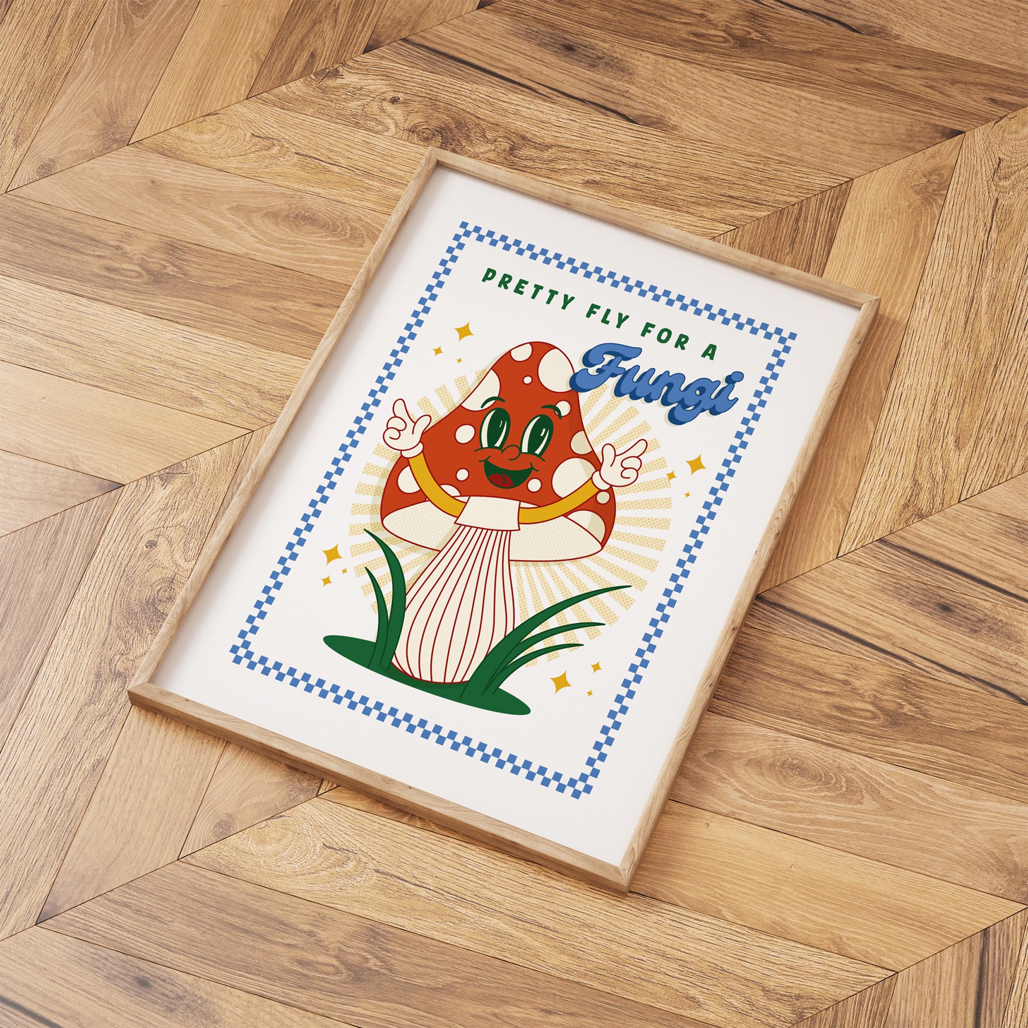 Framed art print of cartoon mushroom laid out on a wooden floor.